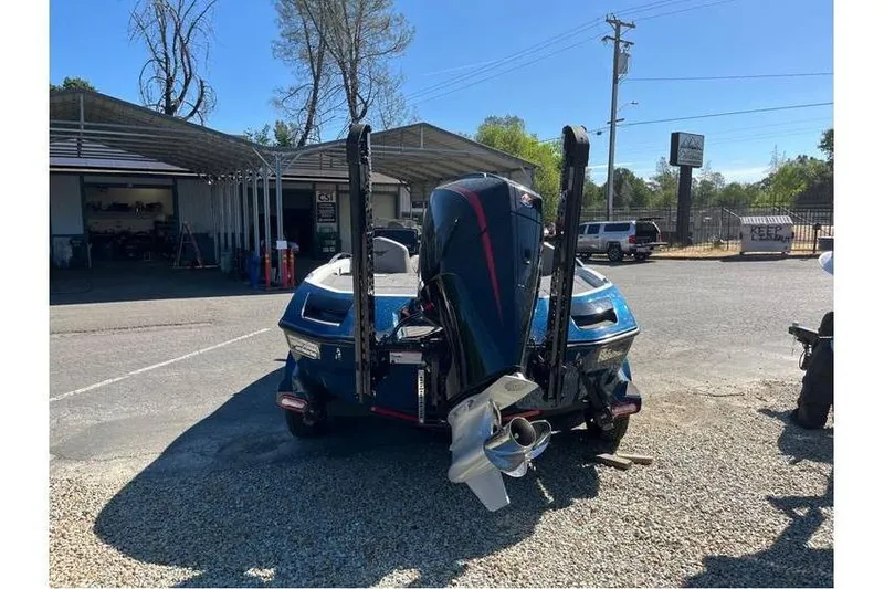 Slide: The Image of 2024 Vexus VX20 boat with powerful outboard motor in a parking area. - 3