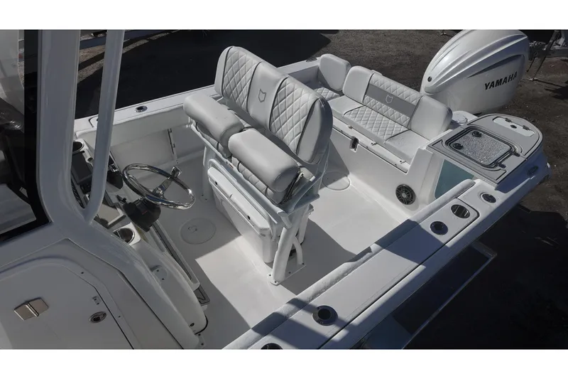 Slide: The Image of Interior view of a Sea Fox boat with Yamaha engine, featuring cushioned seating and steering wheel. - 10