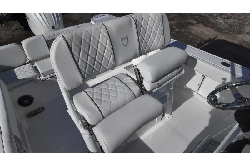 Slide: The Image of White Sea Fox boat seating with diamond stitching and adjustable armrests. - 11