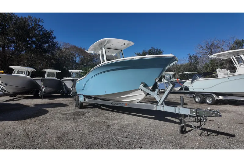 Slide: The Image of Sea Fox boat on trailer, surrounded by other boats, under clear blue sky. - 2