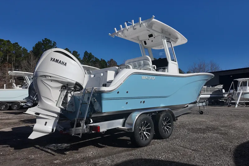 Slide: The Image of Blue Sea Fox boat with Yamaha engine on a trailer, parked outdoors. - 3