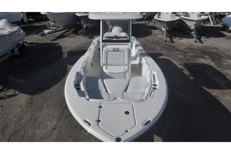 Slide: The Image of Sea Fox boat with cushioned seating, parked on a gravel lot. - 8