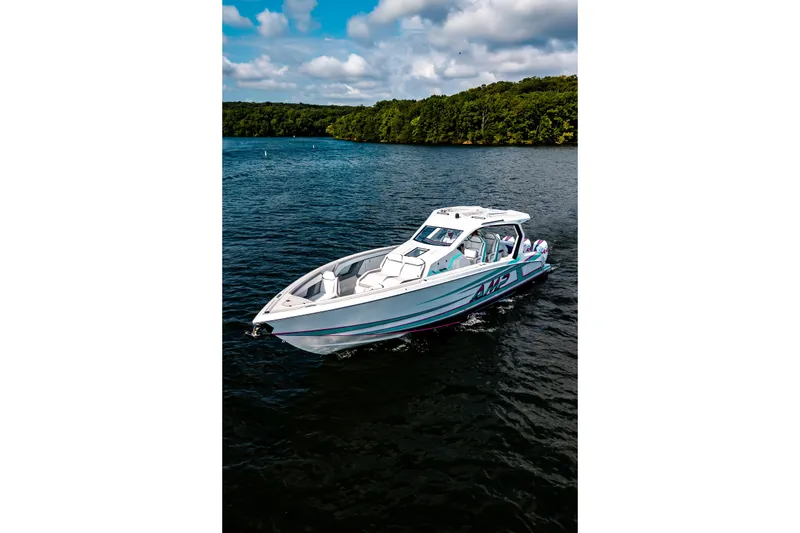 Slide: The Image of Modern AMP 443 boat cruising on a serene lake, 2025 model. - 33