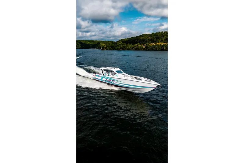 Slide: The Image of A sleek AMP 443 boat cruising on a scenic lake, 2025 model. - 34