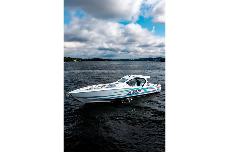 Slide: The Image of 2025 AMP 443 speedboat cruising on a lake under a cloudy sky. - 37