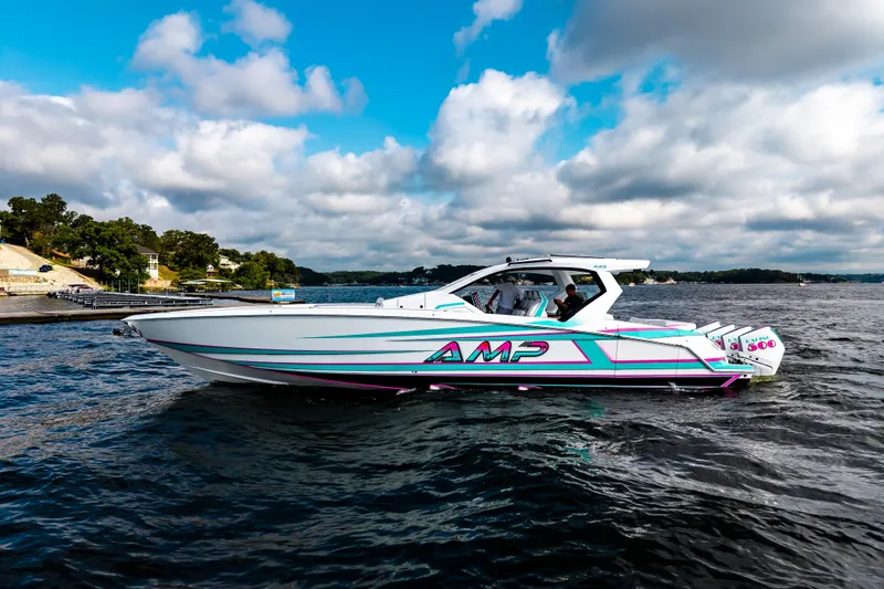 Slide: The Image of 2025 AMP 443 speedboat on a lake under a partly cloudy sky. - 38