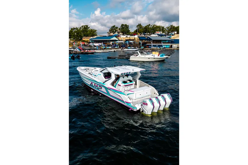 Slide: The Image of Modern AMP 443 boat cruising near a marina, 2025 model, vibrant design, clear skies. - 39