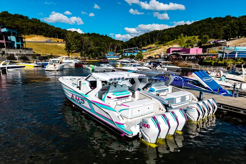 Slide: The Image of Luxury AMP 443 speedboat docked at a vibrant marina, 2025 model. - 43