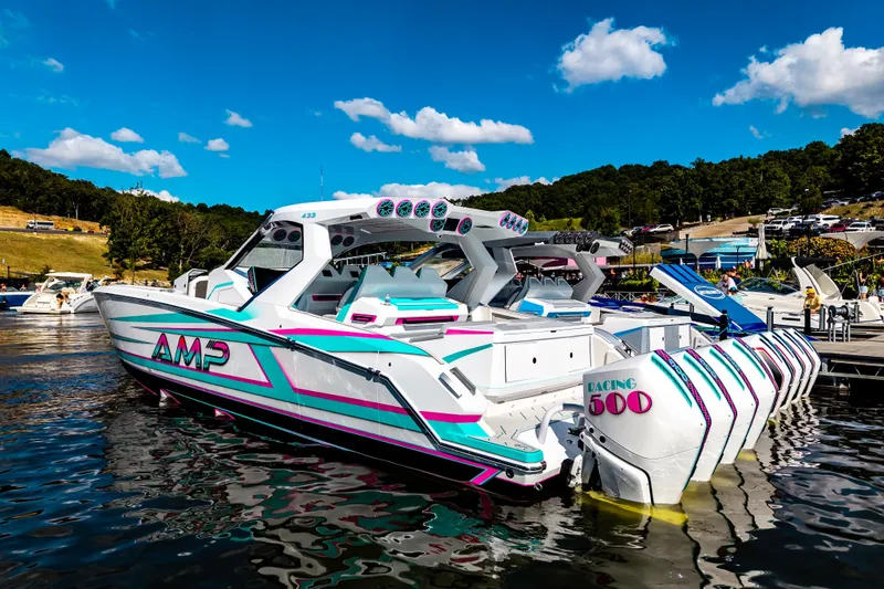 Slide: The Image of Futuristic 2025 AMP 443 speedboat with vibrant design docked on a sunny day. - 45