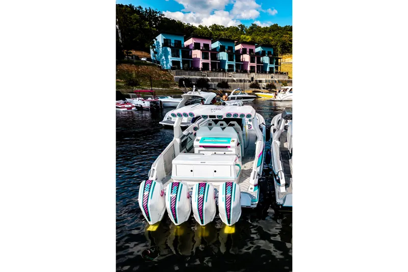 Slide: The Image of Luxury AMP 443 speedboat docked near colorful waterfront buildings, 2025 model. - 46