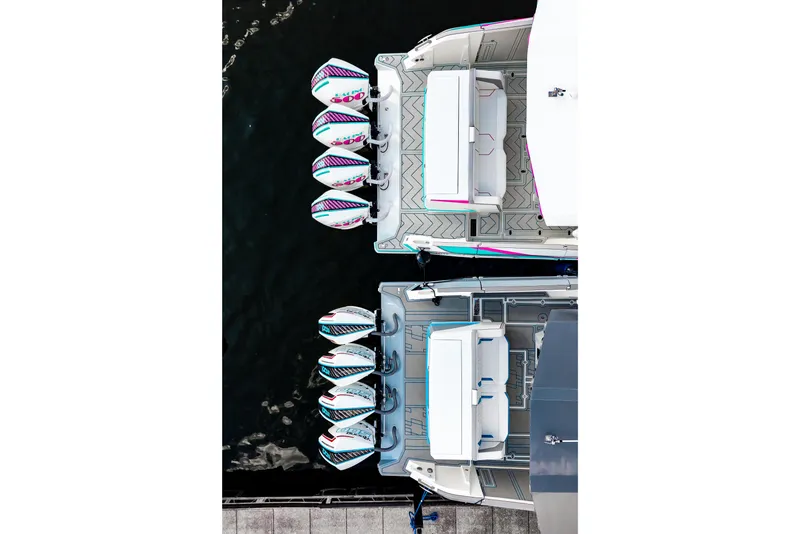 Slide: The Image of Aerial view of two AMP 443 boats, 2025 model, docked with multiple outboard engines. - 48