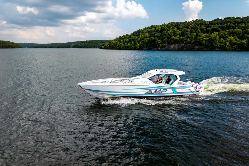 Slide: The Image of High-performance AMP 443 speedboat cruising on a scenic lake, 2025 model. - 6