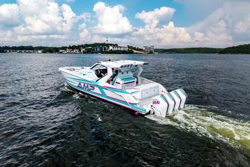 Slide: The Image of 2025 AMP 443 boat cruising on a lake under a partly cloudy sky. - 8