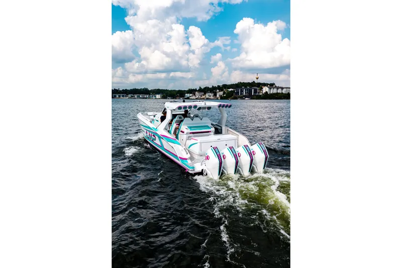 Slide: The Image of Futuristic AMP 443 boat cruising on a lake under a cloudy sky, 2025 model. - 9
