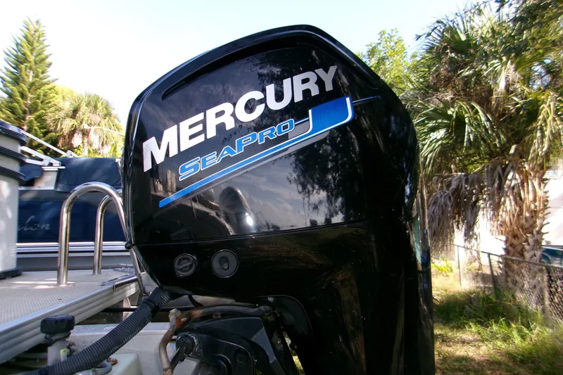 Slide: The Image of Mercury SeaPro engine on 2023 Crest Classic DLX 220 L boat, surrounded by lush greenery. - 6