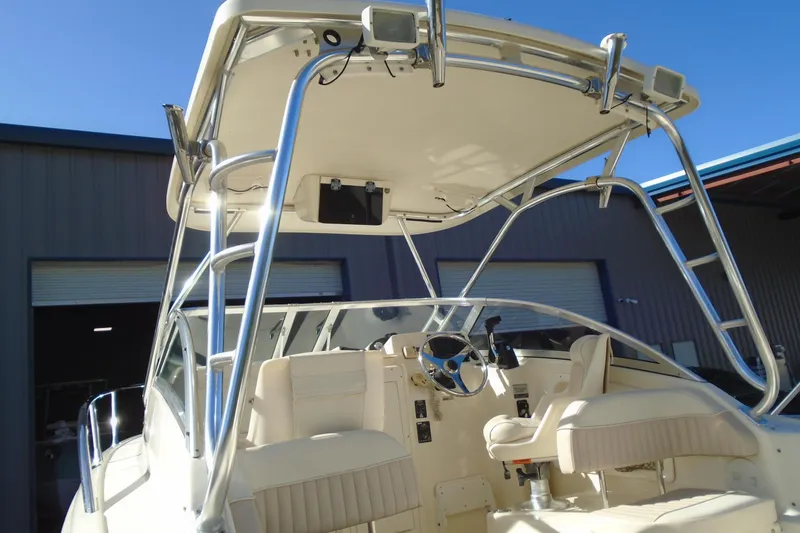 Slide: The Image of 2004 Scout 242 Abaco boat interior with steering wheel and seating. - 12