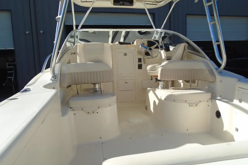 Slide: The Image of 2004 Scout 242 Abaco boat interior with seating and steering wheel. - 13