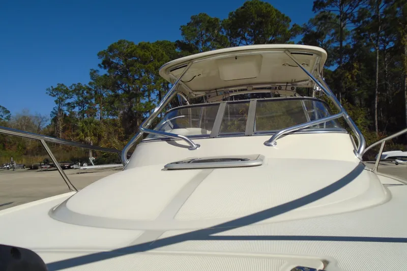Slide: The Image of 2004 Scout 242 Abaco boat with sleek design, docked under clear blue sky. - 16