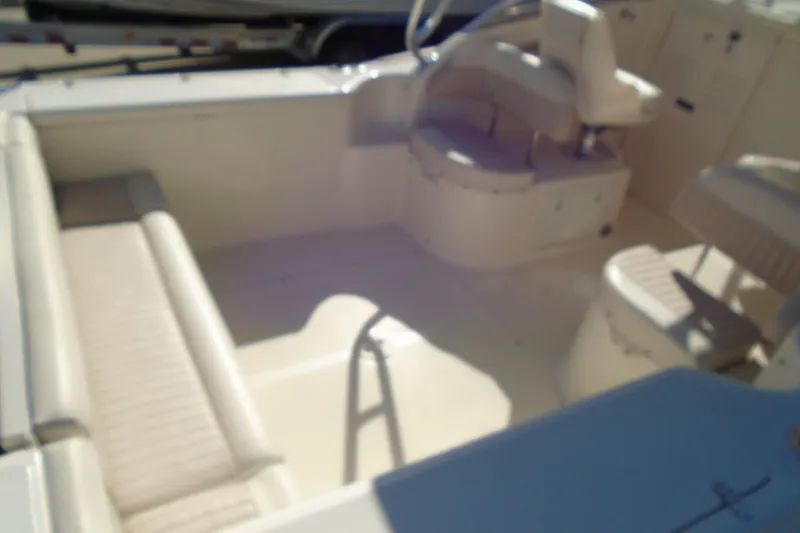 Slide: The Image of 2004 Scout 242 Abaco boat interior with seating and steering area. - 17