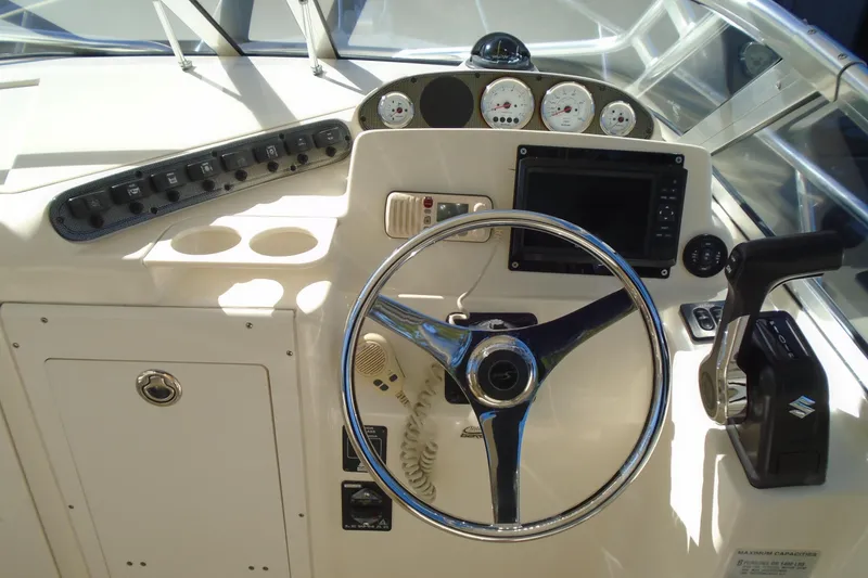 Slide: The Image of 2004 Scout 242 Abaco boat dashboard with steering wheel and control panel. - 18
