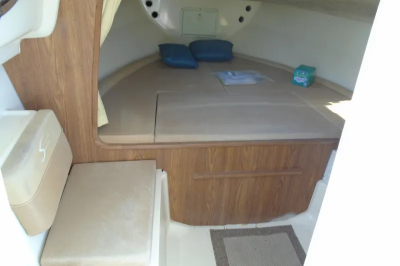 Slide: The Image of 2004 Scout 242 Abaco cabin interior with cushions and wood paneling. - 19