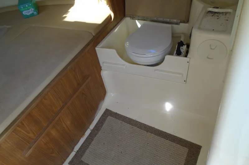 Slide: The Image of 2004 Scout 242 Abaco boat interior with toilet and wooden cabinetry. - 20