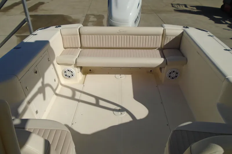 Slide: The Image of 2004 Scout 242 Abaco boat interior with beige seating and storage compartments. - 21