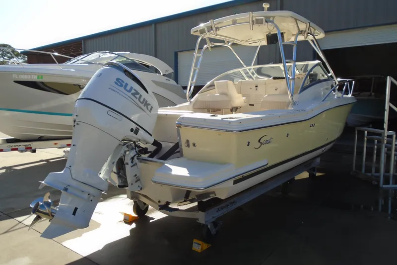 Slide: The Image of 2004 Scout 242 Abaco boat with Suzuki outboard motor in a marina setting. - 3