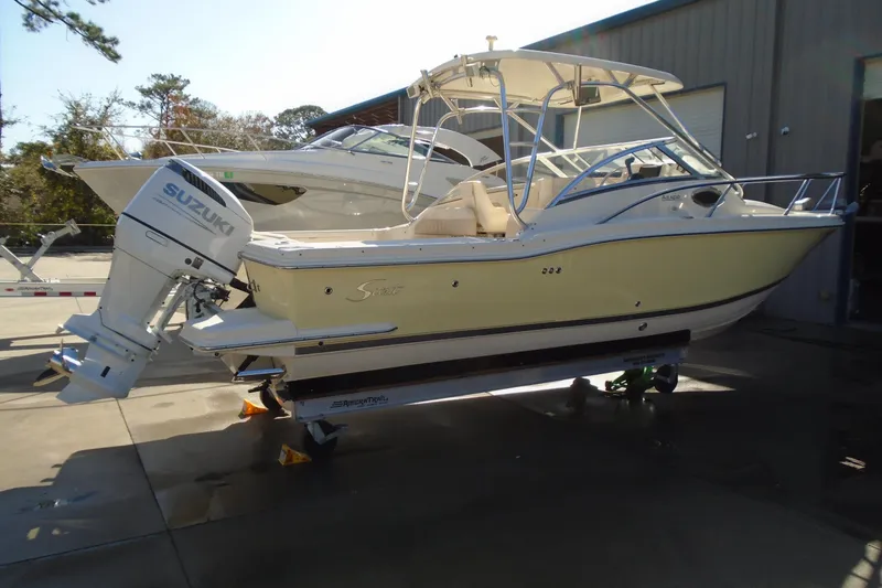 Slide: The Image of 2004 Scout 242 Abaco boat with Suzuki outboard motor on trailer. - 4