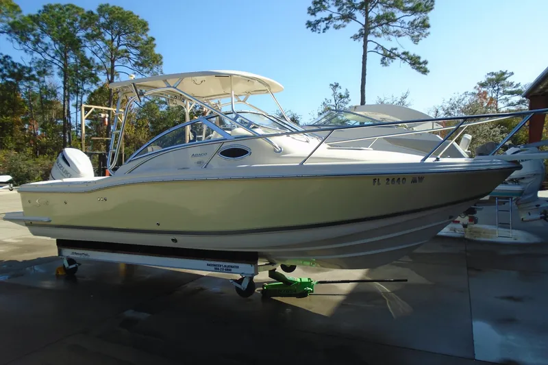 Slide: The Image of 2004 Scout 242 Abaco boat on trailer, parked outdoors with trees in background. - 5