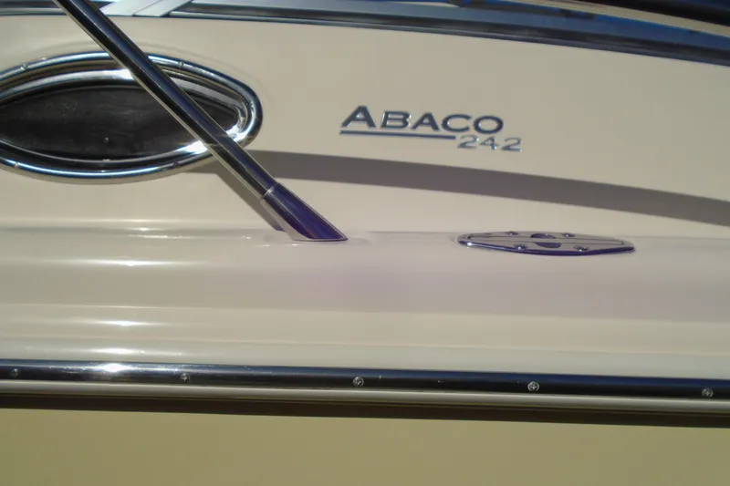 Slide: The Image of Close-up of 2004 Scout 242 Abaco boat exterior with logo and chrome details. - 8