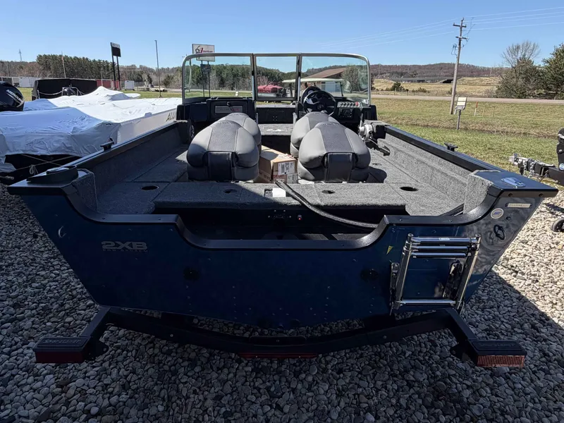 Slide: The Image of 2026 Alumacraft CLASSIC 165/SP boat parked on gravel surface. - 8