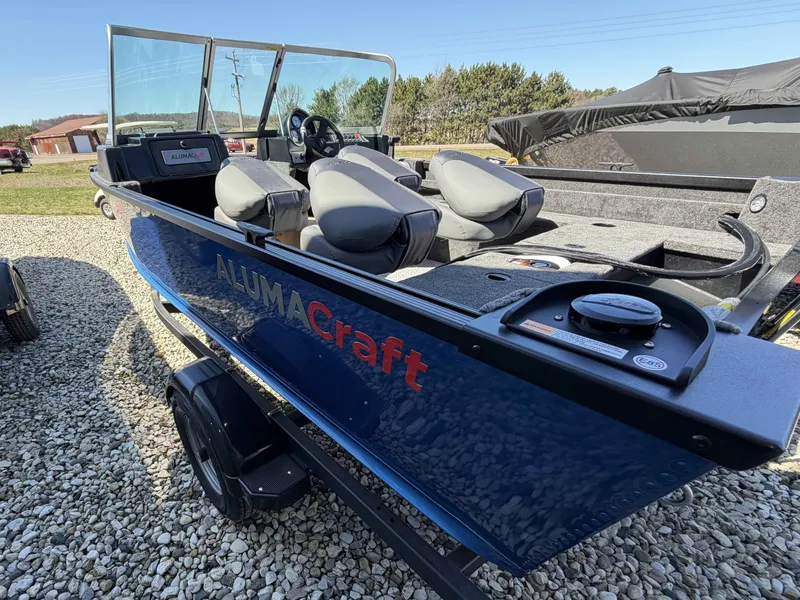 Slide: The Image of 2026 Alumacraft CLASSIC 165/SP boat parked on gravel surface. - 9