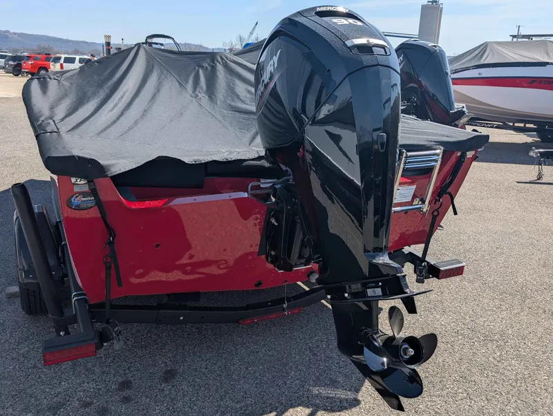 Slide: The Image of Red 2026 Lund 1700 EXP/SS boat with outboard motor. - 11