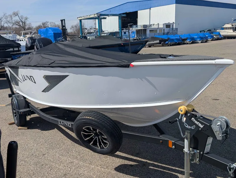 Slide: The Image of 2026 Lund 1675 ADV/SS boat on trailer, covered, outdoors. - 3