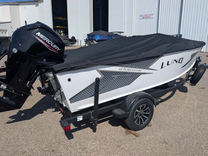 Slide: The Image of 2026 Lund 1675 Adventure boat with Mercury engine, covered on trailer. - 4