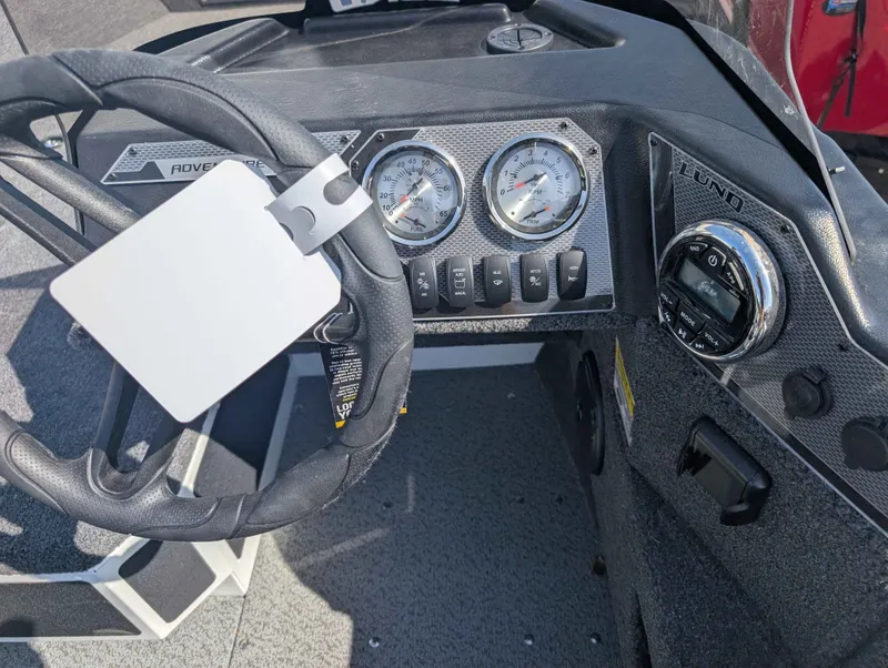 Slide: The Image of Dashboard of 2026 Lund 1675 ADV/SS boat with steering wheel and gauges. - 9