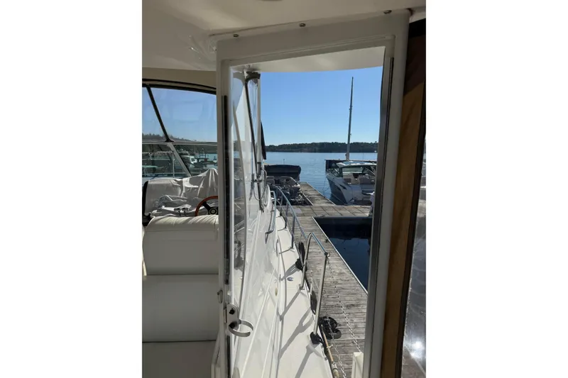 Slide: The Image of 2003 Cruisers Yachts 4050 Express docked at marina, sunny day view. - 13