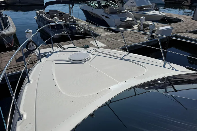 Slide: The Image of 2003 Cruisers Yachts 4050 Express docked at marina, showcasing sleek deck design. - 15