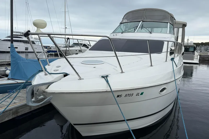 Slide: The Image of 2003 Cruisers Yachts 4050 Express docked at marina, front view. - 3