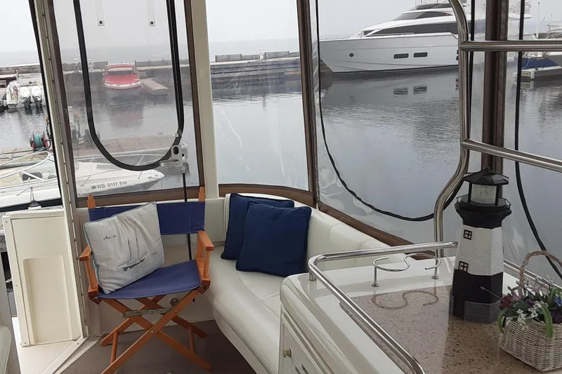 Slide: The Image of Interior of 2003 Cruisers Yachts 4050 Express with seating and marina view. - 7