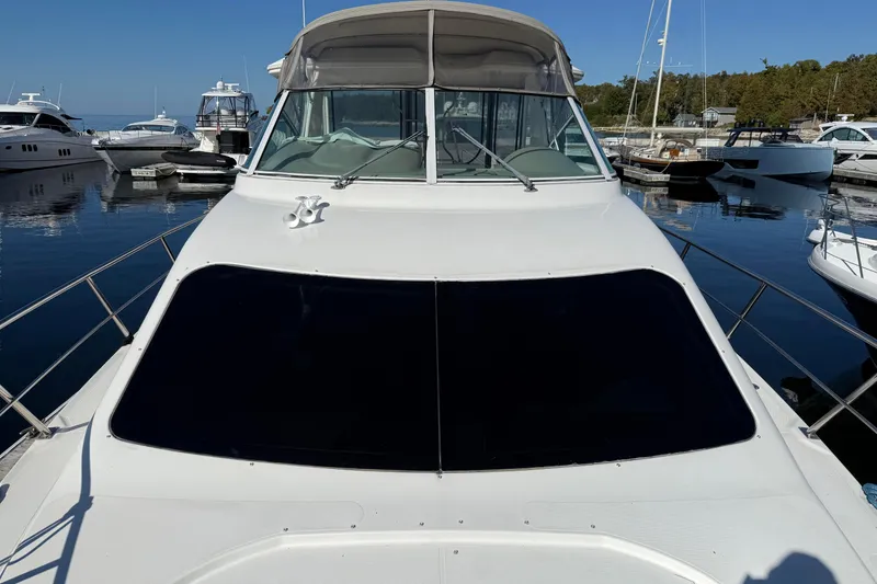 Slide: The Image of 2003 Cruisers Yachts 4050 Express docked in a marina, front view. - 14