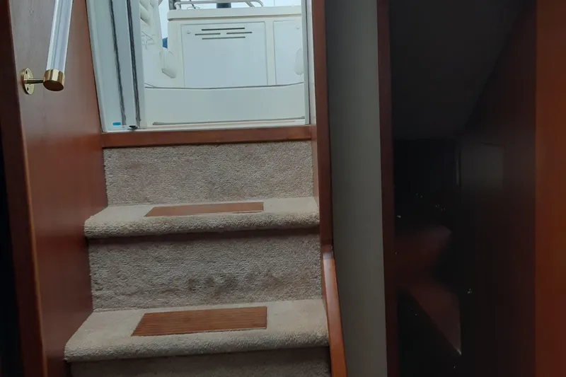 Slide: The Image of Staircase inside 2003 Cruisers Yachts 4050 Express, leading to upper deck area. - 18