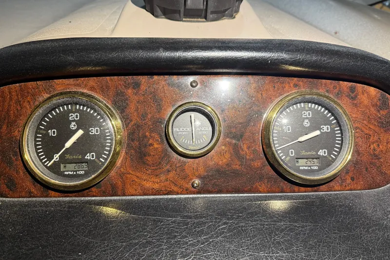 Slide: The Image of Dashboard of 2003 Cruisers Yachts 4050 Express with RPM gauges and rudder angle indicator. - 25