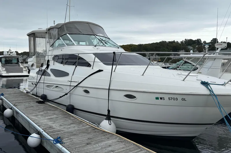 Slide: The Image of 2003 Cruisers Yachts 4050 Express docked at marina, overcast sky. - 4
