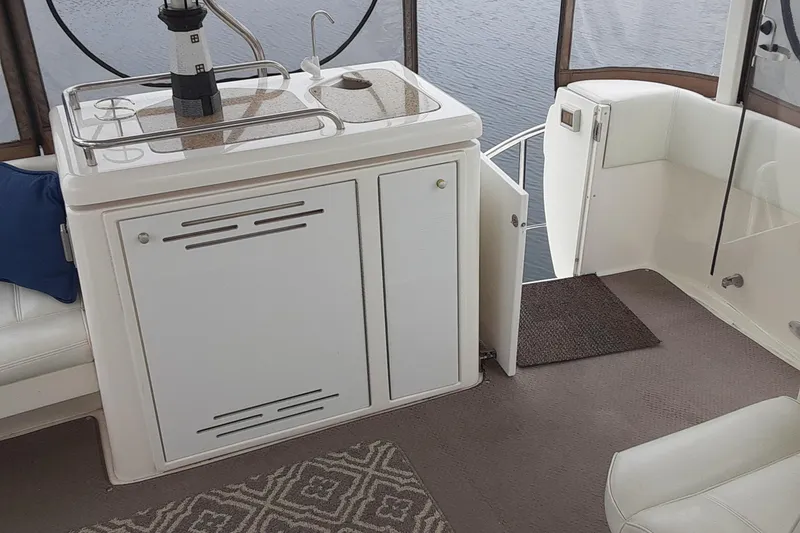 Slide: The Image of 2003 Cruisers Yachts 4050 Express interior with kitchenette and seating area. - 8