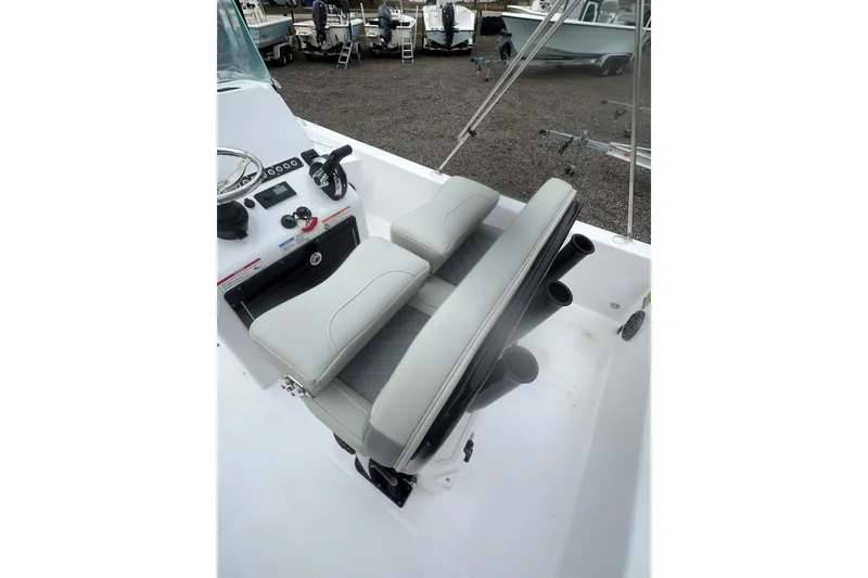 Slide: The Image of 2026 Action Craft 22 Bay boat interior with steering console and cushioned seating. - 15
