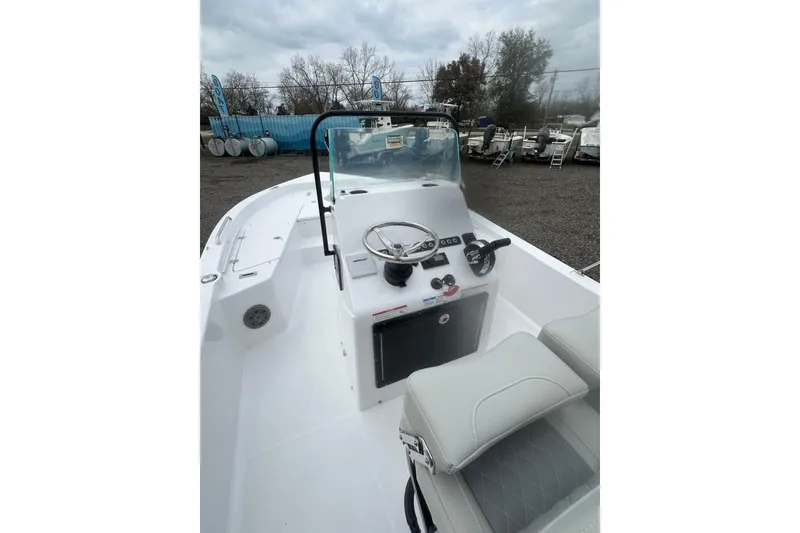 Slide: The Image of 2026 Action Craft 22 Bay boat interior with steering console and seating. - 16