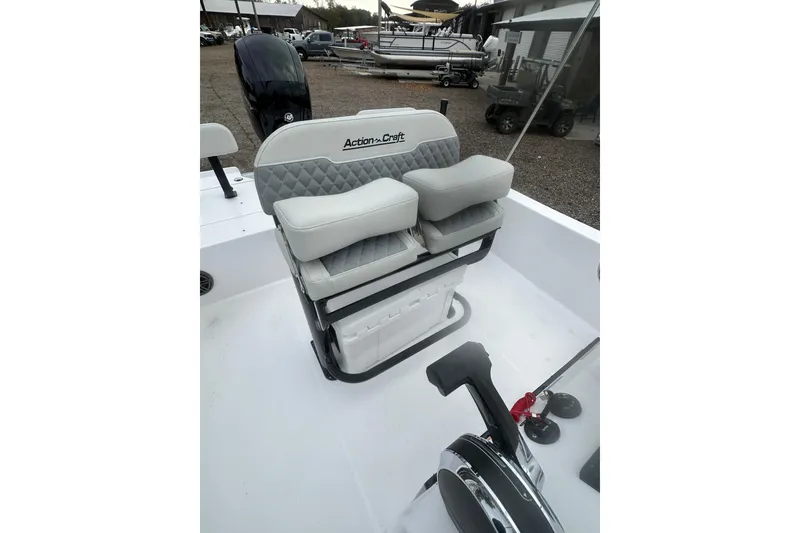Slide: The Image of 2026 Action Craft 22 Bay boat interior with cushioned seating and control panel. - 25