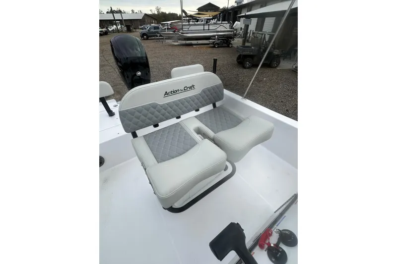 Slide: The Image of 2026 Action Craft 22 Bay boat with dual cushioned seats and outboard motor. - 26